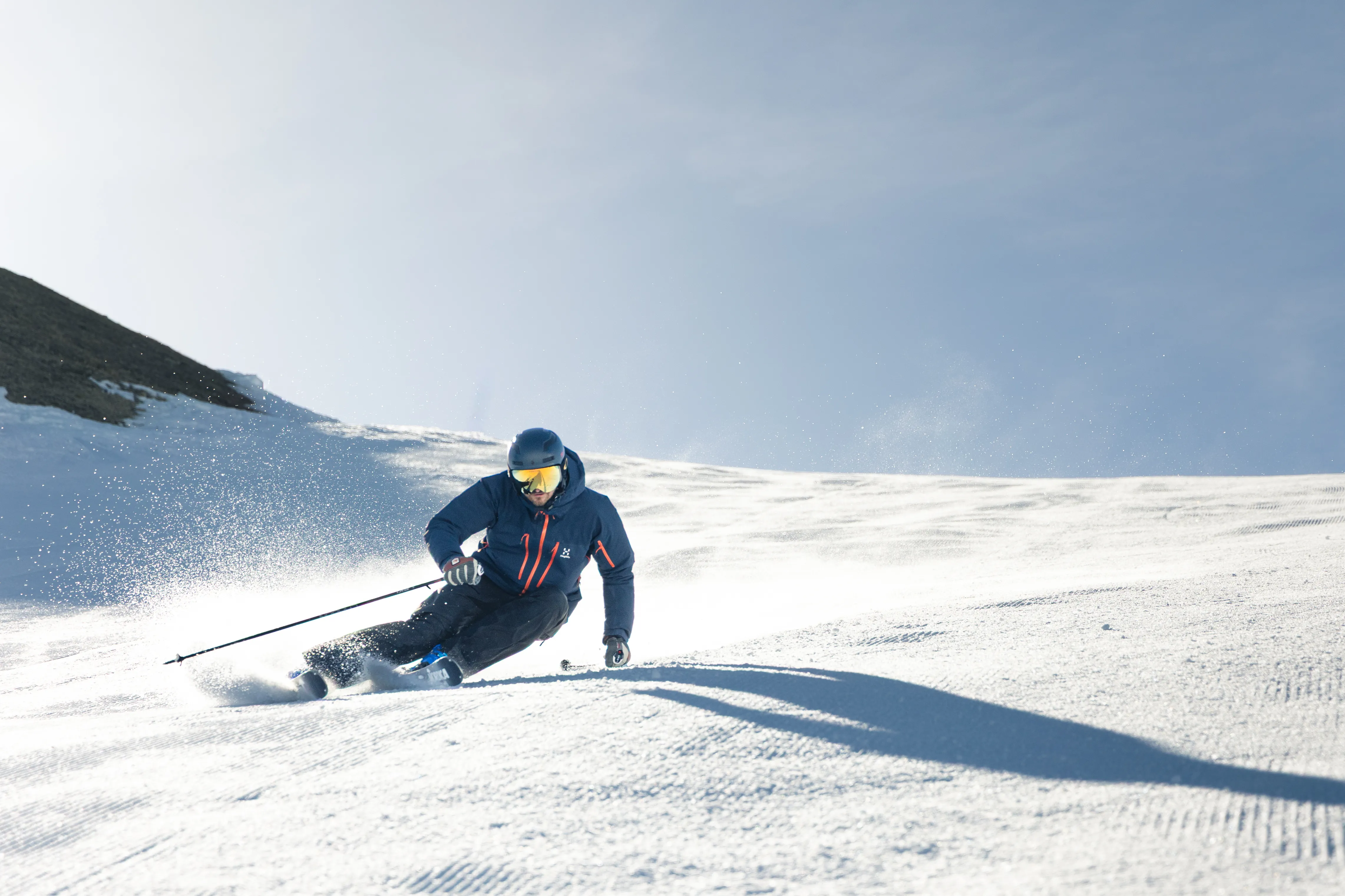 Image of a skier carving a turn in the snow, showcasing precision and control.